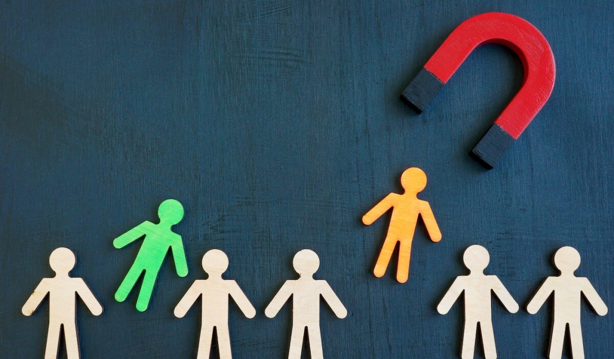 The magnet attracts figures from the crowd. Talent acquisition concept.
